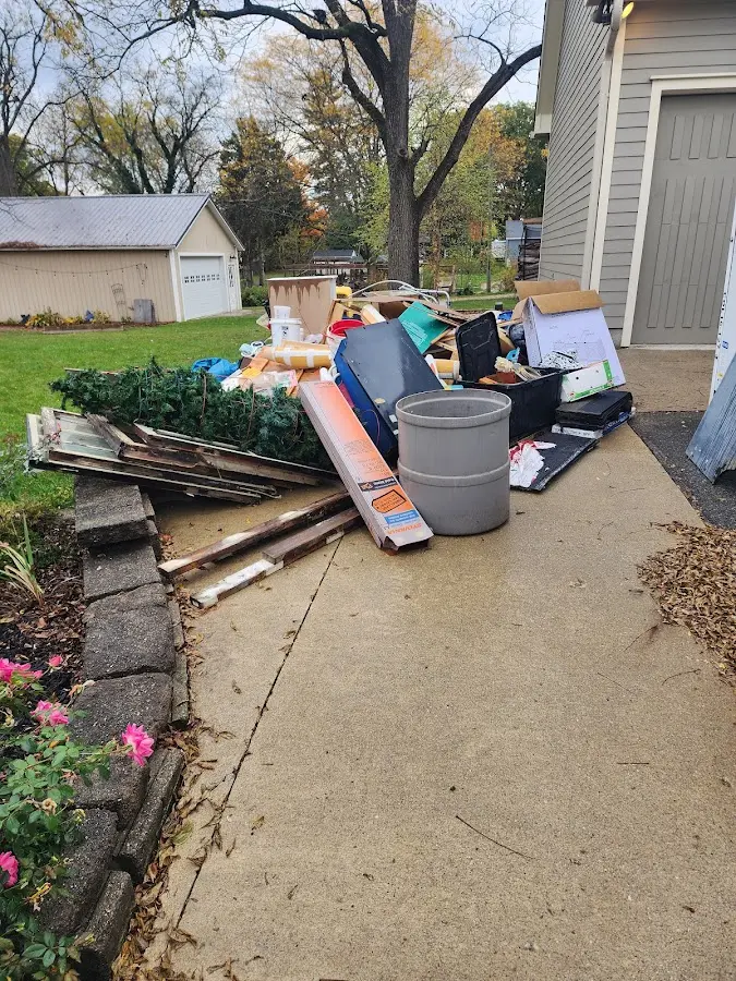 Dumpster being loaded with debris for Residential Dumpster Rental in Belleville